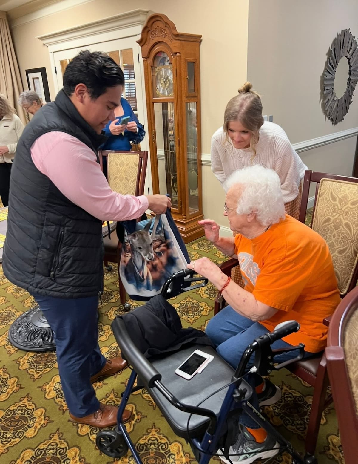 Dale showing Sophie to an elderly resident